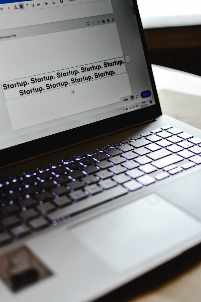 Close-up of a laptop displaying repeated Startup text, symbolizing tech innovation.